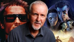 James Cameron in front of the posters for Avatar 2 and The Terminator