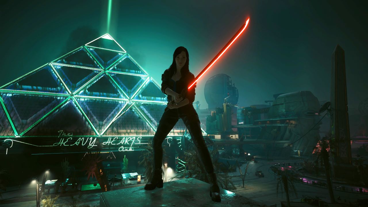 Image of the main player character standing on a rooftop looking over a pyramid shaped building named the "Heavy Hearts Club". A katana is being wielded by the player and it has a red glow attached to it.