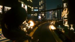 Player character in Cyberpunk 2077 aiming in mid-air and firing with a pistol.