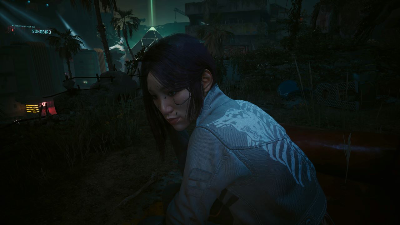 Image of Songbird in Cyberpunk 2077 Phantom Liberty. There is a pyramid building in the background and Songbird is leaning while chatting to the character.