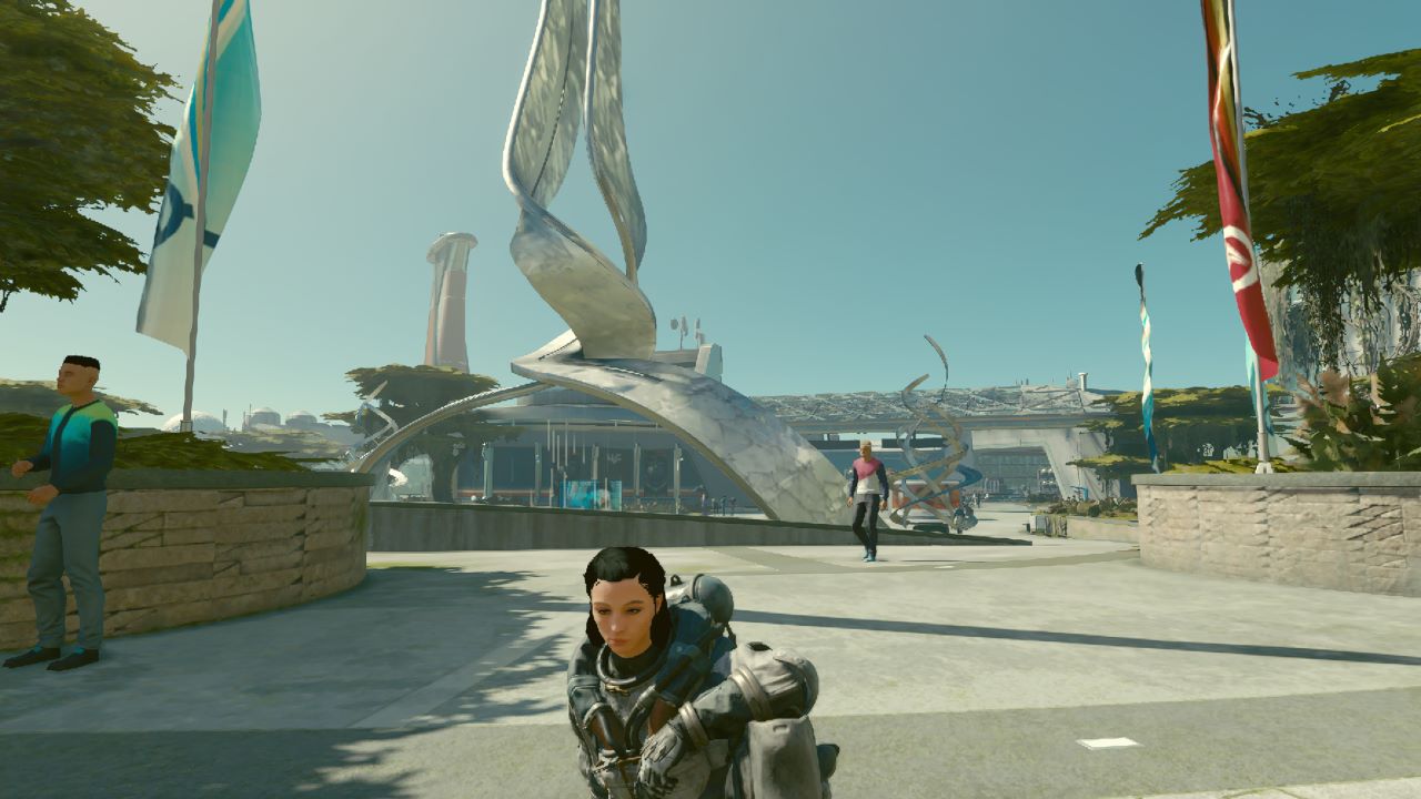 Image from Starfield in New Atlantis, the player character is sitting on the ground with a towering skyscraper-like building in the background.