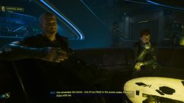 Image showcasing the section of Phantom Liberty where the player is talking to Hansen. There is a glowing table on display.