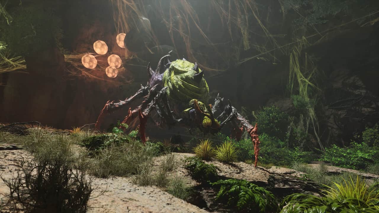 A big spider in the forest looking green and mean in Ark Survival Ascended.