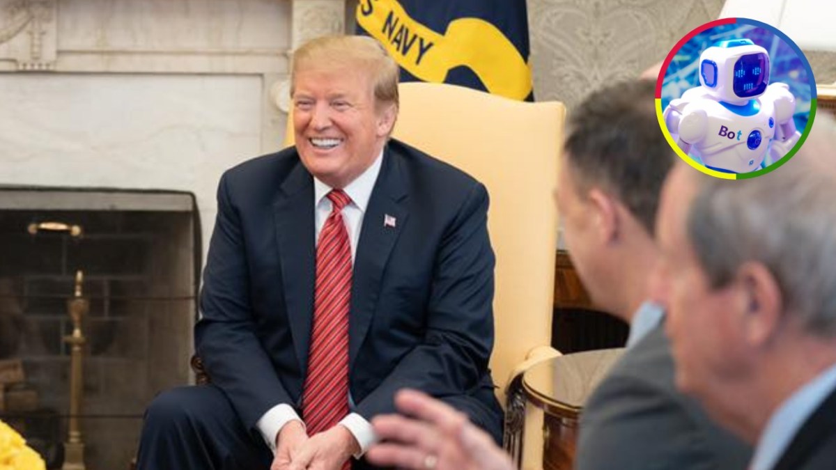 Donald Trump seated and smiling during a meeting, with an inset image of a small blue-and-white robot.